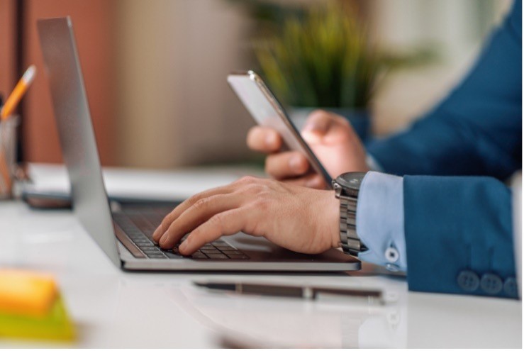 someone on phone looking at compute 